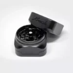 a black grinder with a lid